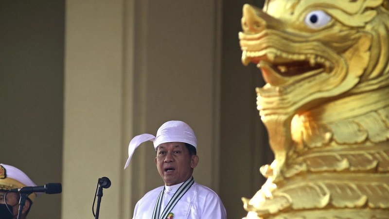 A man gestures with his hands while onboard a bus with prisoners leaving Insein prison during the Union Day holiday in Yangon, Myanmar, Saturday, Feb. 12, 2022. In a customary gesture for national holidays, the head of Myanmar's military government, Senior General Min Aung Hlaing announced an amnesty Saturday covering more than 860 prisoners, state-run newspapers reported. (AP Photo)