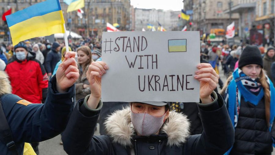 Ukrainians attend a rally in central Kyiv, Ukraine, Saturday, Feb. 12, 2022, during a protest against the potential escalation of the tension between Russia and Ukraine. Russian President Vladimir Putin and U.S. President Joe Biden are to hold a high-stakes telephone call on Saturday as tensions over a possibility imminent invasion of Ukraine escalated sharply and the U.S. announced plans to evacuate its embassy in the Ukrainian capital. (AP Photo/Efrem Lukatsky)