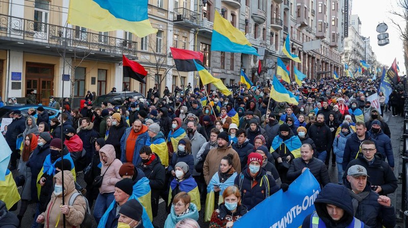 Ukrainians attend a rally in central Kyiv, Ukraine, Saturday, Feb. 12, 2022, during a protest against the potential escalation of the tension between Russia and Ukraine. Russian President Vladimir Putin and U.S. President Joe Biden are to hold a high-stakes telephone call on Saturday as tensions over a possibility imminent invasion of Ukraine escalated sharply and the U.S. announced plans to evacuate its embassy in the Ukrainian capital. (AP Photo/Efrem Lukatsky)