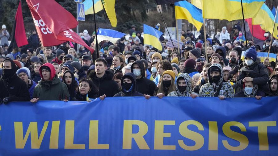 Ukrainians attend a rally in central Kyiv, Ukraine, Saturday, Feb. 12, 2022, during a protest against the potential escalation of the tension between Russia and Ukraine. Russian President Vladimir Putin and U.S. President Joe Biden are to hold a high-stakes telephone call on Saturday as tensions over a possibility imminent invasion of Ukraine escalated sharply and the U.S. announced plans to evacuate its embassy in the Ukrainian capital. (AP Photo/Efrem Lukatsky)