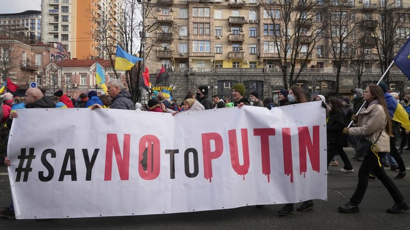 Ukrainians attend a rally in central Kyiv, Ukraine, Saturday, Feb. 12, 2022, during a protest against the potential escalation of the tension between Russia and Ukraine. Russian President Vladimir Putin and U.S. President Joe Biden are to hold a high-stakes telephone call on Saturday as tensions over a possibility imminent invasion of Ukraine escalated sharply and the U.S. announced plans to evacuate its embassy in the Ukrainian capital. (AP Photo/Efrem Lukatsky)