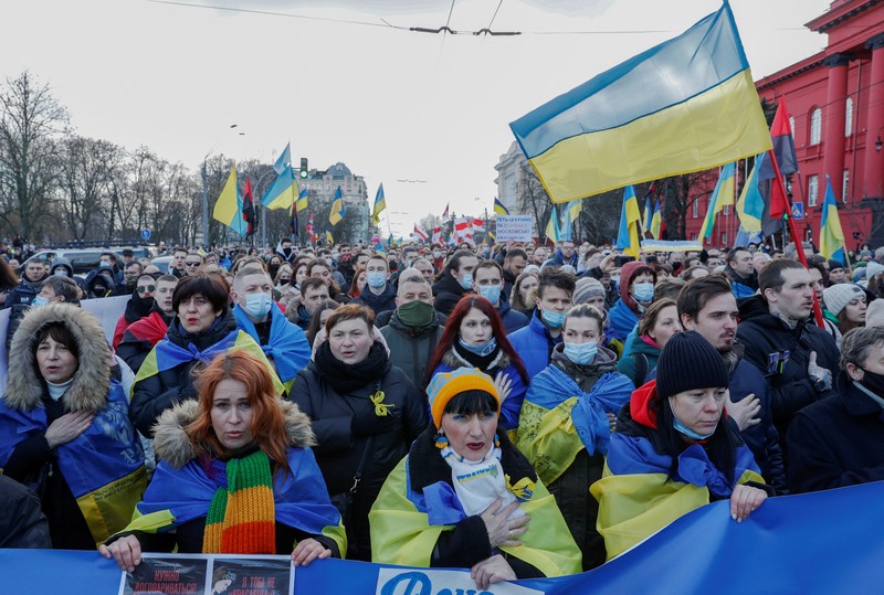 Ukrainians attend a rally in central Kyiv, Ukraine, Saturday, Feb. 12, 2022, during a protest against the potential escalation of the tension between Russia and Ukraine. Russian President Vladimir Putin and U.S. President Joe Biden are to hold a high-stakes telephone call on Saturday as tensions over a possibility imminent invasion of Ukraine escalated sharply and the U.S. announced plans to evacuate its embassy in the Ukrainian capital. (AP Photo/Efrem Lukatsky)