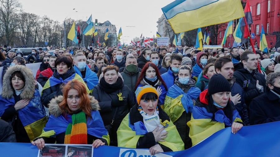 Ukrainians attend a rally in central Kyiv, Ukraine, Saturday, Feb. 12, 2022, during a protest against the potential escalation of the tension between Russia and Ukraine. Russian President Vladimir Putin and U.S. President Joe Biden are to hold a high-stakes telephone call on Saturday as tensions over a possibility imminent invasion of Ukraine escalated sharply and the U.S. announced plans to evacuate its embassy in the Ukrainian capital. (AP Photo/Efrem Lukatsky)