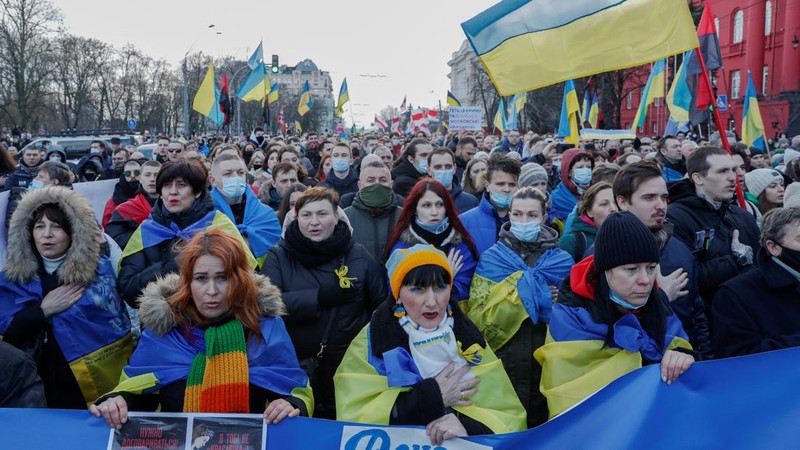 Ukrainians attend a rally in central Kyiv, Ukraine, Saturday, Feb. 12, 2022, during a protest against the potential escalation of the tension between Russia and Ukraine. Russian President Vladimir Putin and U.S. President Joe Biden are to hold a high-stakes telephone call on Saturday as tensions over a possibility imminent invasion of Ukraine escalated sharply and the U.S. announced plans to evacuate its embassy in the Ukrainian capital. (AP Photo/Efrem Lukatsky)