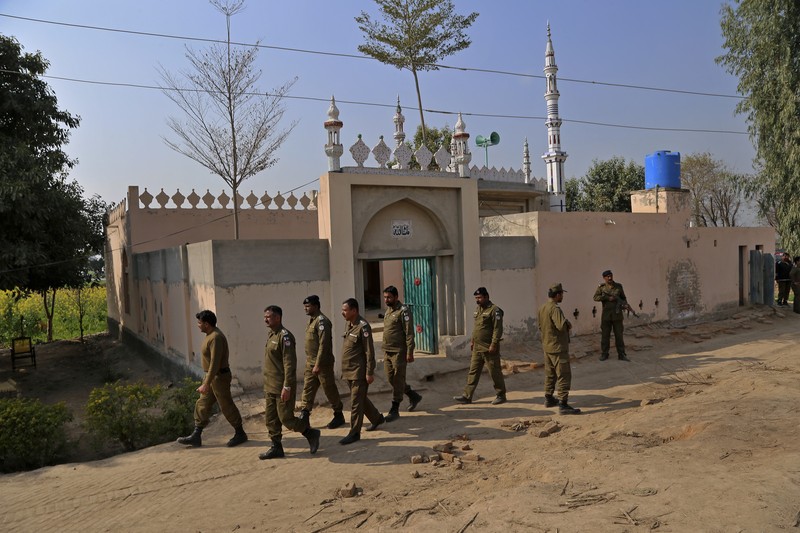 Pria di Pakistan diduga membakar Al-Qur'an Petugas kepolisian berjaga di sebuah masjid, di mana massa yang marah melempari Mushtaq Ahmed (41) dengan batu hingga tewas karena diduga menodai Alquran, di Tulamba, sebuah desa terpencil di distrik Khanewal di Pakistan timur, Minggu (13/2/2022). Serangan massa terhadap orang-orang yang dituduh melakukan penistaan adalah hal biasa di negara Islam konservatif ini di mana penistaan dapat dihukum mati. (AP Photo/Asim Tanveer)