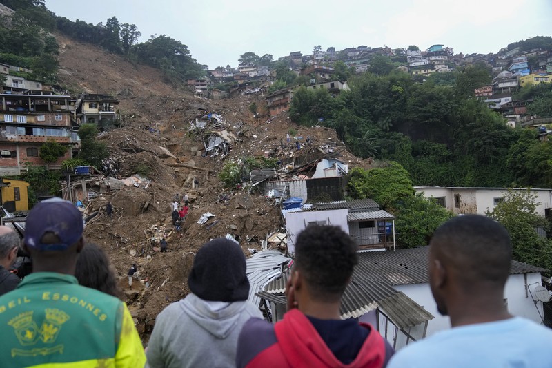Brazil Deadly Rains Rescue workers and residents search for victims in an area affected by landslides in Petropolis, Brazil, Wednesday, Feb. 16, 2022. Extremely heavy rains set off mudslides and floods in a mountainous region of Rio de Janeiro state, killing multiple people, authorities reported. (AP Photo/Silvia Izquierdo)