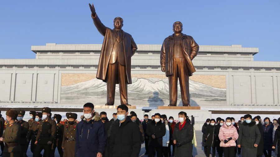 Citizens visit the statues of their late leaders Kim Il Sung, left, and Kim Jong Il on Mansu Hill in Pyongyang, North Korea on the occasion of the 80th birth anniversary of Kim Jong Il on Wednesday, Feb. 16, 2022. (AP Photo/Jon Chol Jin)