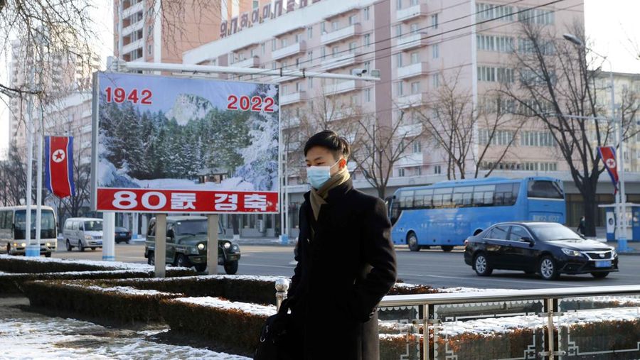A North Korean walks past a celebrative poster displayed on the occasion of the 80th birth anniversary of the country's late leader Kim Jong Il in Pyongyang, North Korea Wednesday, Feb. 16, 2022. (AP Photo/Jon Chol Jin)