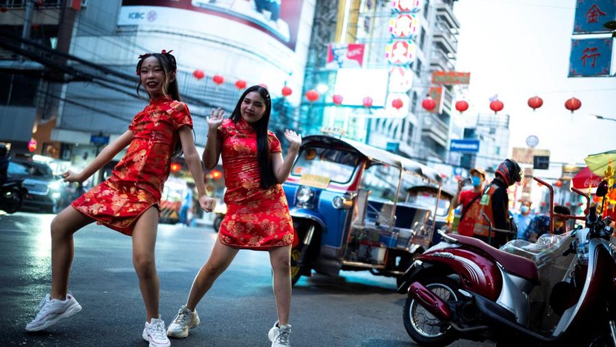 Girls wearing Chinese costumes dance ahead of the Chinese Lunar New Year celebrations amid the coronavirus disease (COVID-19) outbreak in Bangkok's Chinatown, Thailand, January 27, 2022. REUTERS/Athit Perawongmetha