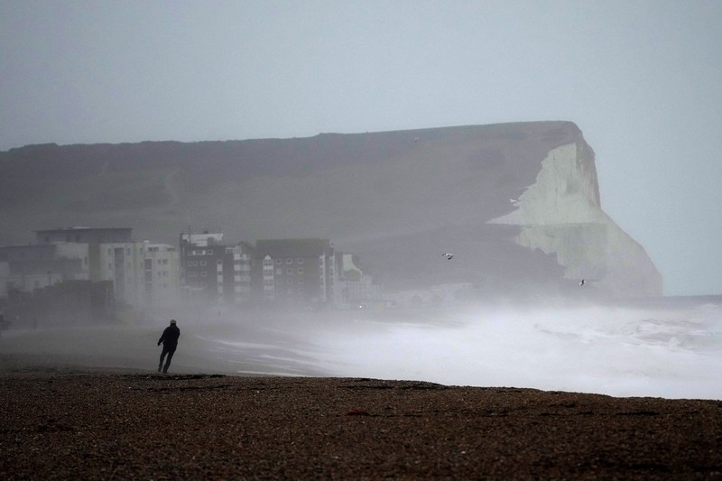 Waves crash over the Newhaven harbour breakwater and lighthouse, as Storm Eunice hits Newhaven, on the south coast of England, Friday, Feb. 18, 2022. Millions of Britons are being urged to cancel travel plans and stay indoors Friday amid fears of high winds and flying debris as the second major storm this week prompted a rare 