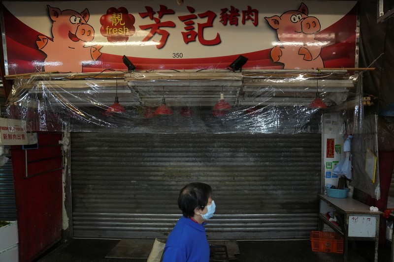 Medical workers wearing personal protective equipment (PPE), work next to patients at a makeshift treatment area outside a hospital, following the coronavirus disease (COVID-19) outbreak in Hong Kong, China February 19, 2022. REUTERS/Aleksander Solum