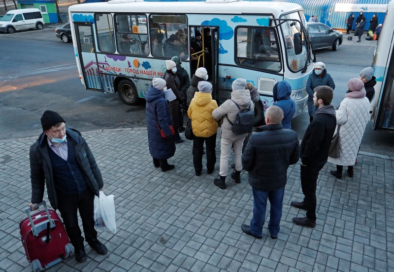 People board a bus during the evacuation of local residents to Russia, in the rebel-controlled city of Donetsk, Ukraine February 19, 2022. REUTERS/Alexander Ermochenko