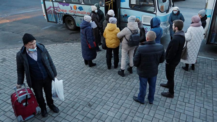 People board a bus during the evacuation of local residents to Russia, in the rebel-controlled city of Donetsk, Ukraine February 19, 2022. REUTERS/Alexander Ermochenko