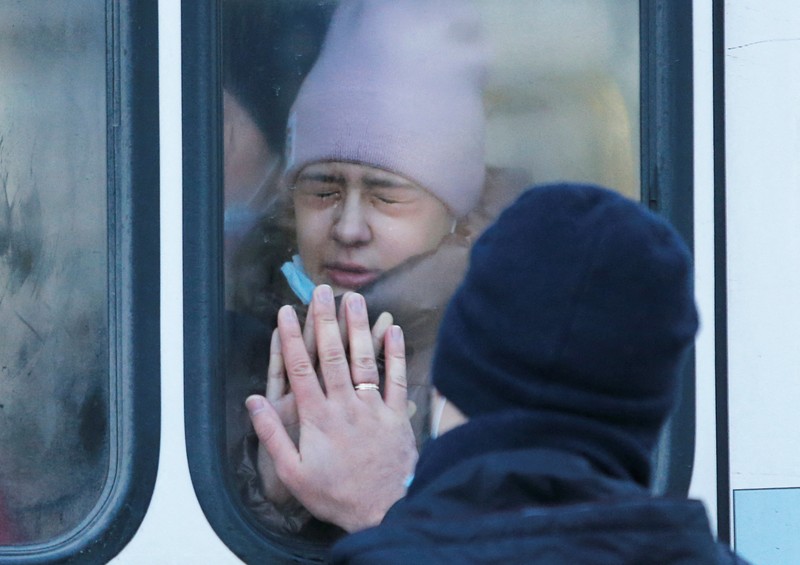 People board a bus during the evacuation of local residents to Russia, in the rebel-controlled city of Donetsk, Ukraine February 19, 2022. REUTERS/Alexander Ermochenko