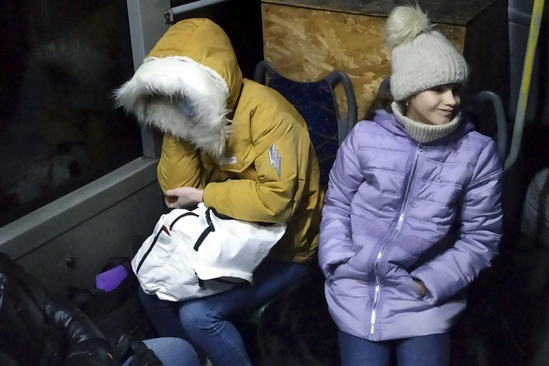 People board a bus during the evacuation of local residents to Russia, in the rebel-controlled city of Donetsk, Ukraine February 19, 2022. REUTERS/Alexander Ermochenko