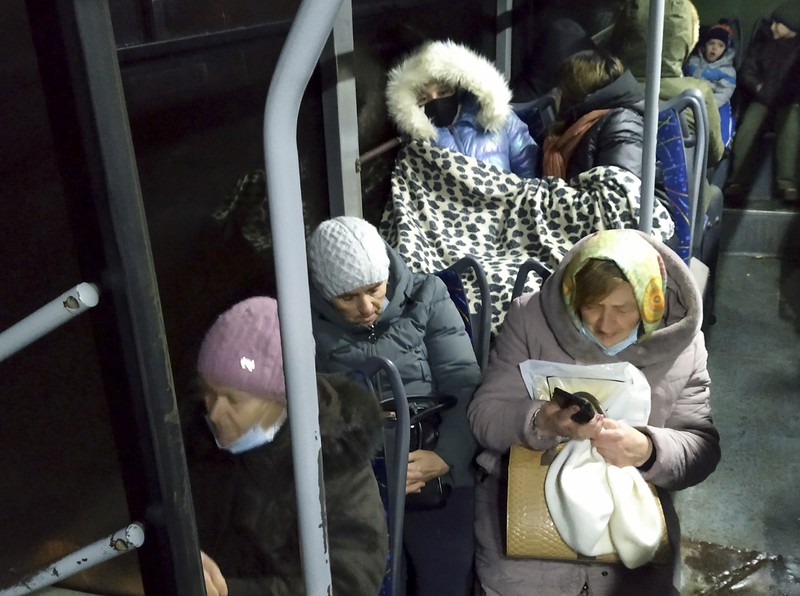 People board a bus during the evacuation of local residents to Russia, in the rebel-controlled city of Donetsk, Ukraine February 19, 2022. REUTERS/Alexander Ermochenko