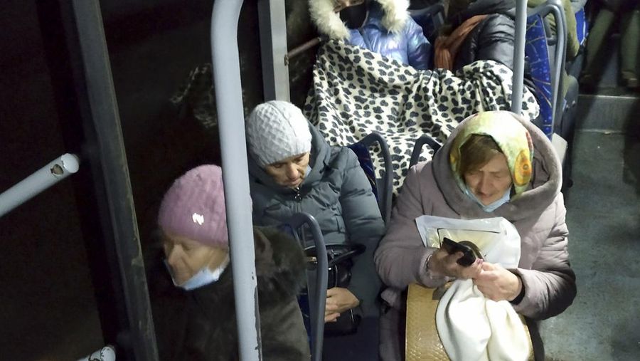 People board a bus during the evacuation of local residents to Russia, in the rebel-controlled city of Donetsk, Ukraine February 19, 2022. REUTERS/Alexander Ermochenko