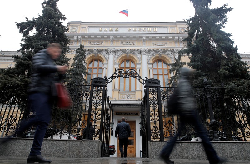 People stand in line to withdraw money from an ATM in Sberbank in St. Petersburg, Russia, Friday, Feb. 25, 2022. Russians flocked to banks and ATMs on Thursday and Friday shortly after Russia launched an attack on Ukraine and the West announced crippling sanctions. According to Russia's Central Bank, on Thursday alone Russians have withdrawn 111 billion rubles (about $1.3 billion) in cash. (AP Photo/Dmitri Lovetsky)