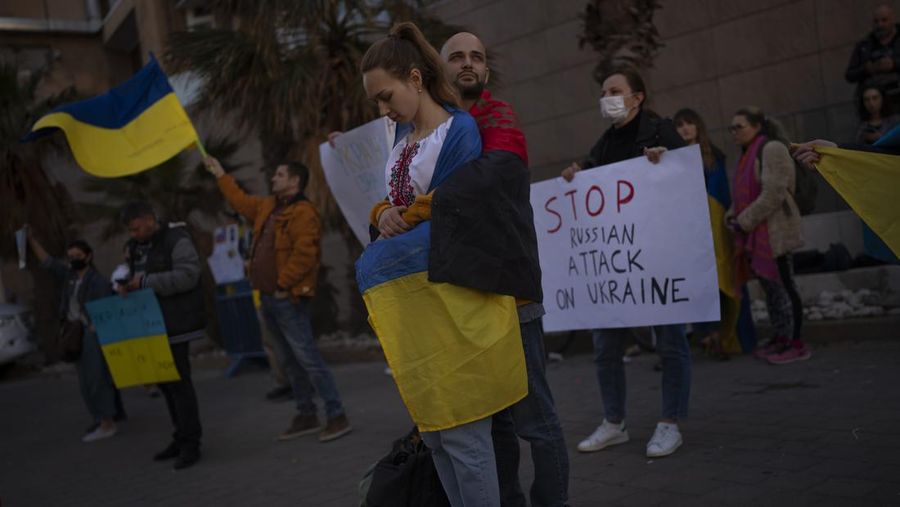 Demonstrators hold placards and flags as they attend a pro-Ukraine protest outside the Russian Embassy, after Russian troops launched their anticipated attack on Ukraine, in Tel Aviv, Israel, Thursday, Feb. 24, 2022. (AP Photo/Oded Balilty)