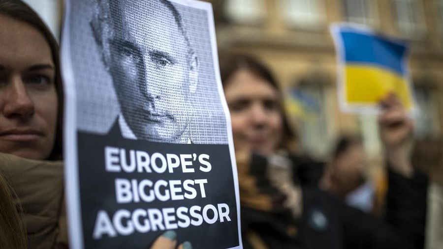 People take part in a protest against the Russian invasion of Ukraine, in Vilnius, Lithuania, Saturday, Feb. 26, 2022. Russian troops stormed toward Ukraine's capital Saturday, and street fighting broke out as city officials urged residents to take shelter. (AP Photo/Mindaugas Kulbis)