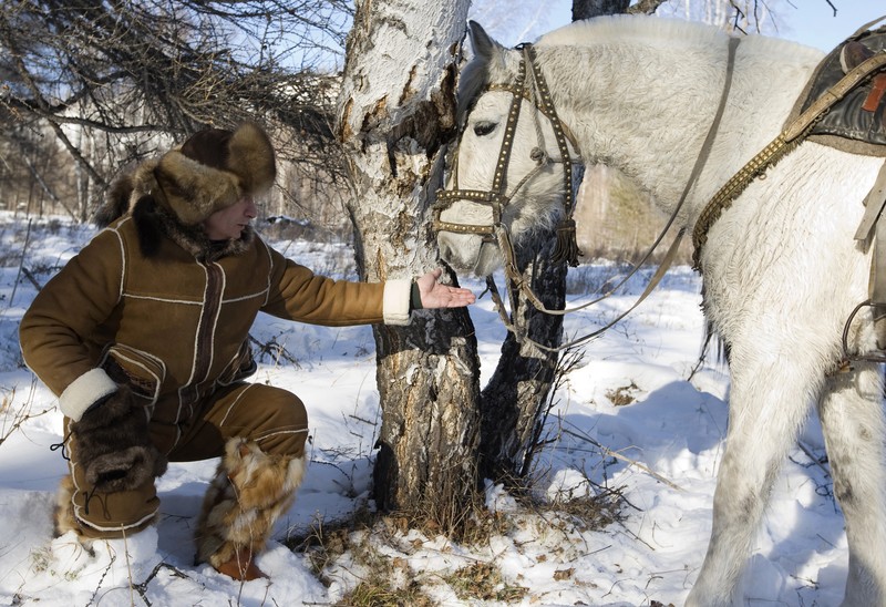 FILE - In this file pool photo taken on Monday, Aug. 3, 2009, the then Russian Prime Minister Vladimir Putin ia seen riding a horse while traveling in the mountains of the Siberian Tyva region (also referred to as Tuva), Russia, during his short vacation. After 18 years as Russia’s leader _ and with another six-year term sure to follow a March election _ Putin doesn’t show the appetites or vulnerabilities that can personalize Western politics, even when staged or spun. If he has moments of merriment or melancholy, they happen in private. (Alexei Druzhinin, Sputnik, Kremlin Pool Photo via AP, file)