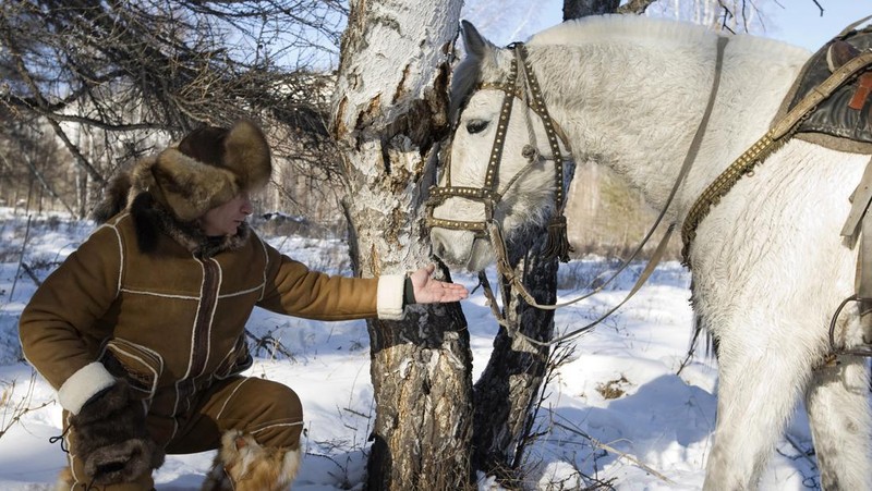 FILE - In this file pool photo taken on Monday, Aug. 3, 2009, the then Russian Prime Minister Vladimir Putin ia seen riding a horse while traveling in the mountains of the Siberian Tyva region (also referred to as Tuva), Russia, during his short vacation. After 18 years as Russia’s leader _ and with another six-year term sure to follow a March election _ Putin doesn’t show the appetites or vulnerabilities that can personalize Western politics, even when staged or spun. If he has moments of merriment or melancholy, they happen in private. (Alexei Druzhinin, Sputnik, Kremlin Pool Photo via AP, file)