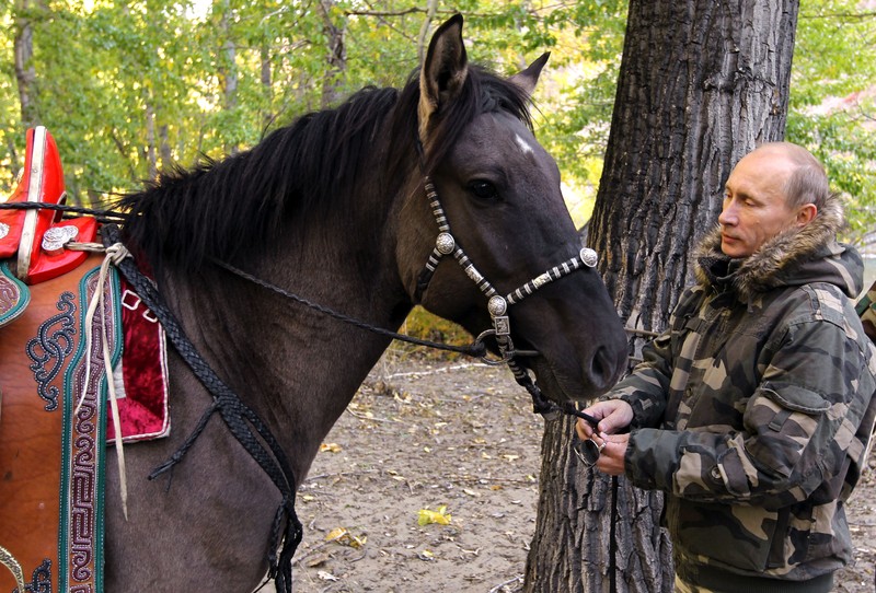 FILE - In this file pool photo taken on Monday, Aug. 3, 2009, the then Russian Prime Minister Vladimir Putin ia seen riding a horse while traveling in the mountains of the Siberian Tyva region (also referred to as Tuva), Russia, during his short vacation. After 18 years as Russia’s leader _ and with another six-year term sure to follow a March election _ Putin doesn’t show the appetites or vulnerabilities that can personalize Western politics, even when staged or spun. If he has moments of merriment or melancholy, they happen in private. (Alexei Druzhinin, Sputnik, Kremlin Pool Photo via AP, file)