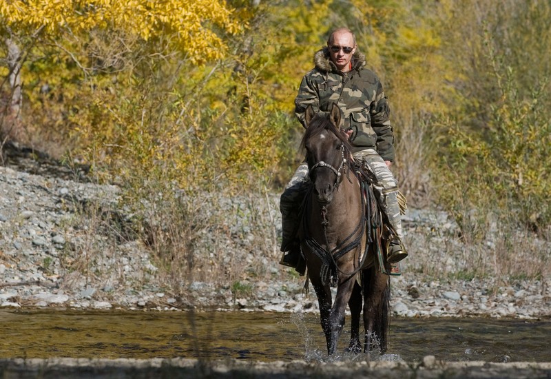 FILE - In this file pool photo taken on Monday, Aug. 3, 2009, the then Russian Prime Minister Vladimir Putin ia seen riding a horse while traveling in the mountains of the Siberian Tyva region (also referred to as Tuva), Russia, during his short vacation. After 18 years as Russia’s leader _ and with another six-year term sure to follow a March election _ Putin doesn’t show the appetites or vulnerabilities that can personalize Western politics, even when staged or spun. If he has moments of merriment or melancholy, they happen in private. (Alexei Druzhinin, Sputnik, Kremlin Pool Photo via AP, file)