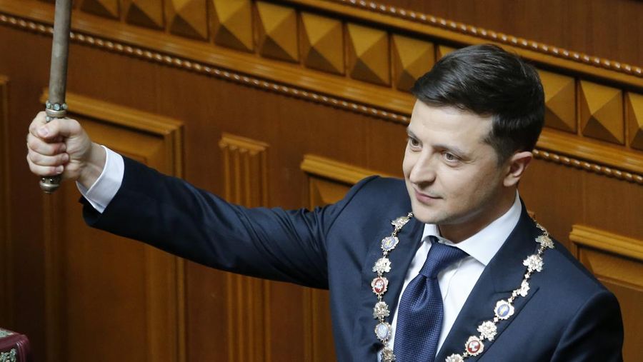 Ukrainian new President Volodymyr Zelenskiy holds the Ukrainian symbols of power during his inauguration ceremony in Kiev, Ukraine, Monday, May 20, 2019. Television star Volodymyr Zelenskiy has been sworn in as Ukraine's next president after he beat the incumbent at the polls last month. The ceremony was held at Ukrainian parliament in Kiev on Monday morning. (AP Photo/Efrem Lukatsky)