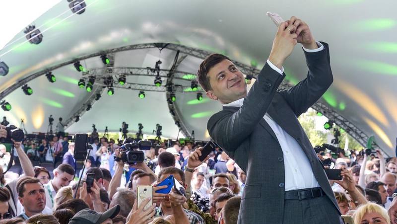 FILE - In this Friday, March 29, 2019 file photo, Volodymyr Zelenskiy, Ukrainian actor and candidate in the upcoming presidential election, hosts a comedy show at a concert hall in Brovary, Ukraine. For his presidential campaign popular Ukrainian comedian Volodymyr Zelenskiy has literally taken the script from a TV show in which he plays the Ukrainian president. (AP Photo/Efrem Lukatsky, file)