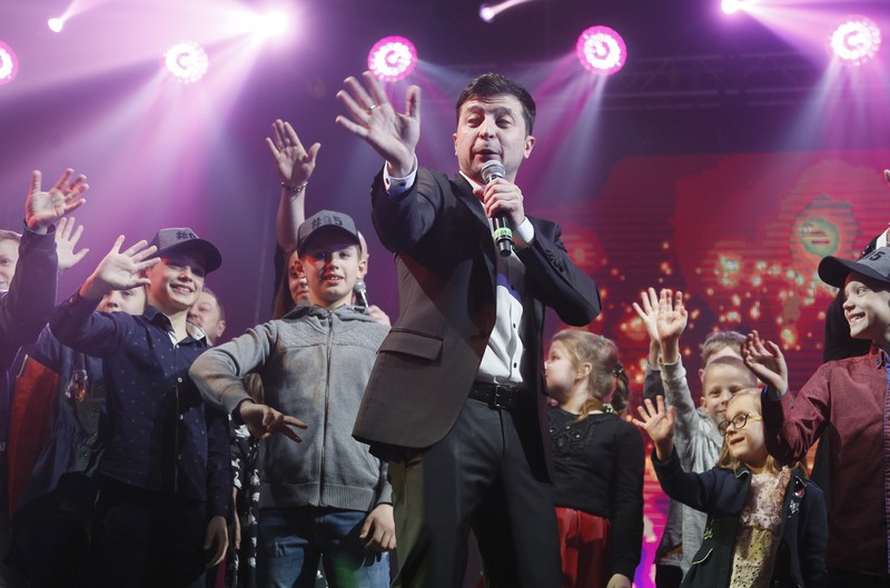 FILE - In this Friday, March 29, 2019 file photo, Volodymyr Zelenskiy, Ukrainian actor and candidate in the upcoming presidential election, hosts a comedy show at a concert hall in Brovary, Ukraine. For his presidential campaign popular Ukrainian comedian Volodymyr Zelenskiy has literally taken the script from a TV show in which he plays the Ukrainian president. (AP Photo/Efrem Lukatsky, file)