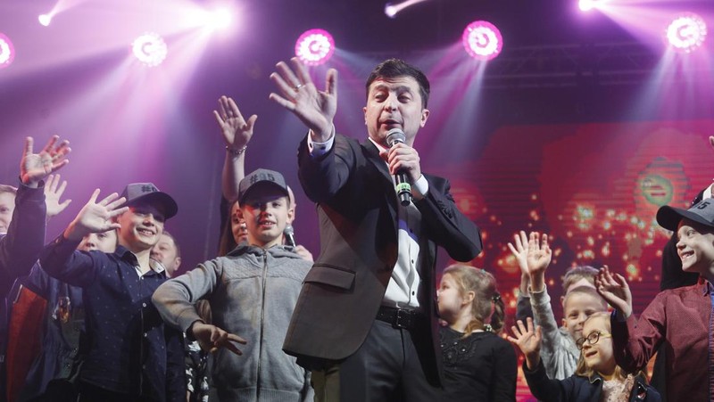 FILE - In this Friday, March 29, 2019 file photo, Volodymyr Zelenskiy, Ukrainian actor and candidate in the upcoming presidential election, hosts a comedy show at a concert hall in Brovary, Ukraine. For his presidential campaign popular Ukrainian comedian Volodymyr Zelenskiy has literally taken the script from a TV show in which he plays the Ukrainian president. (AP Photo/Efrem Lukatsky, file)