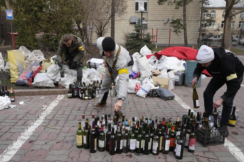 Anggota pertahanan sipil bersenjata berpose untuk foto saat berpatroli di jalan yang kosong karena jam malam di Kyiv, Ukraina,  Minggu (27/2/2022).  (AP Photo/Efrem Lukatsky)