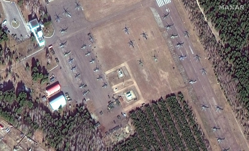 This satellite image provided by Maxar Technologies shows part of military convoy and burning homes northwest of Invankiv, Ukraine Monday, Feb. 28, 2022. (Satellite image ©2022 Maxar Technologies via AP)