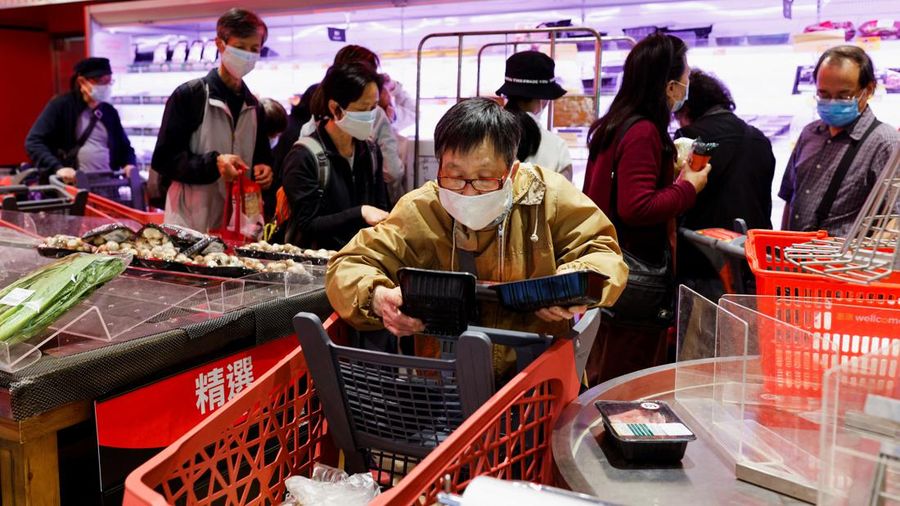 A customer wearing a mask buys fresh meat at a supermarket ahead of mass coronavirus disease (COVID-19) testing in Hong Kong, China March 1, 2022. REUTERS/Tyrone Siu