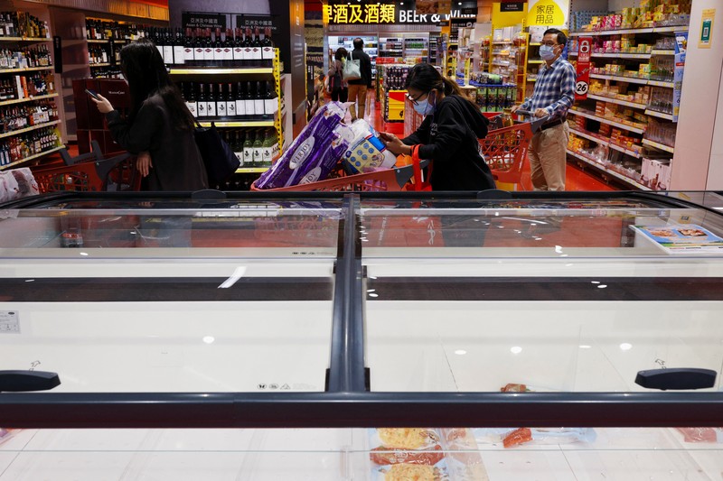 A customer wearing a mask buys fresh meat at a supermarket ahead of mass coronavirus disease (COVID-19) testing in Hong Kong, China March 1, 2022. REUTERS/Tyrone Siu