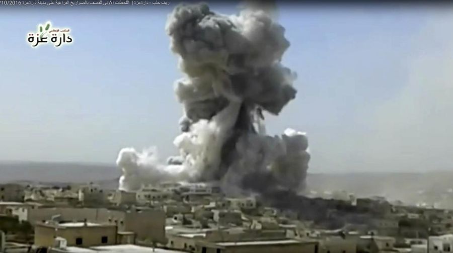 In this still image taken from video footage provided by the Daret Izza Media Office, an anti-government activist group, which has been authenticated based on its contents and other AP reporting, a big blast is seen at the edge of the city accompanied by a large plume of smoke and debris rising from the skyline, Daret Izza, Syria, Tuesday, Oct. 4, 2016. Activists say the explosion was caused by a thermobaric rocket launched by forces loyal to the Syrian government. (Daret Izza Media Office via AP)