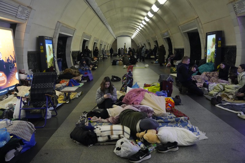 People gather in the Kyiv subway, using it as a bomb shelter in Kyiv, Ukraine, Wednesday, March 2, 2022. Russian forces have escalated their attacks on crowded cities in what Ukraine's leader called a blatant campaign of terror. (AP Photo/Efrem Lukatsky)