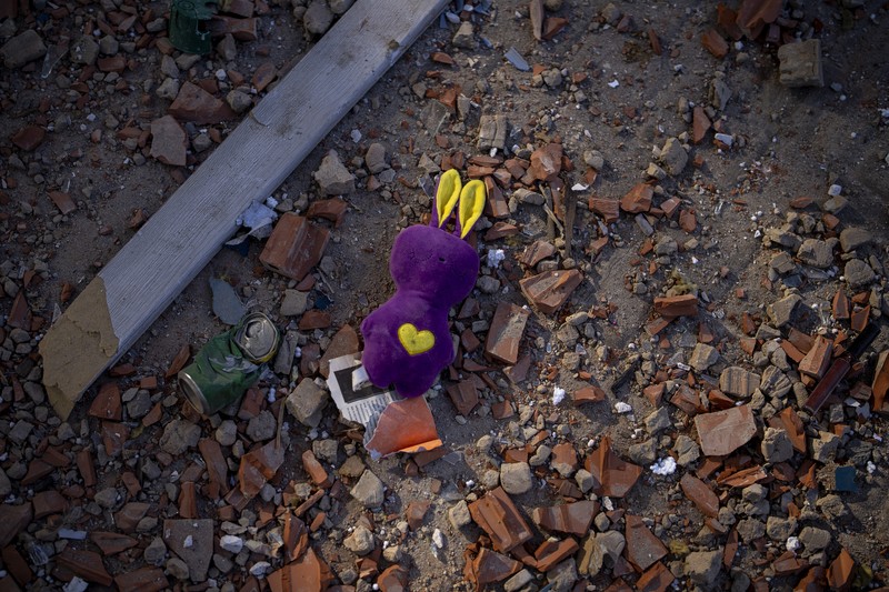 A toy sits among the debris near an apartment building damaged following a rocket attack, in Kyiv, Ukraine, Saturday, Feb. 26, 2022. (AP Photo/Emilio Morenatti)
