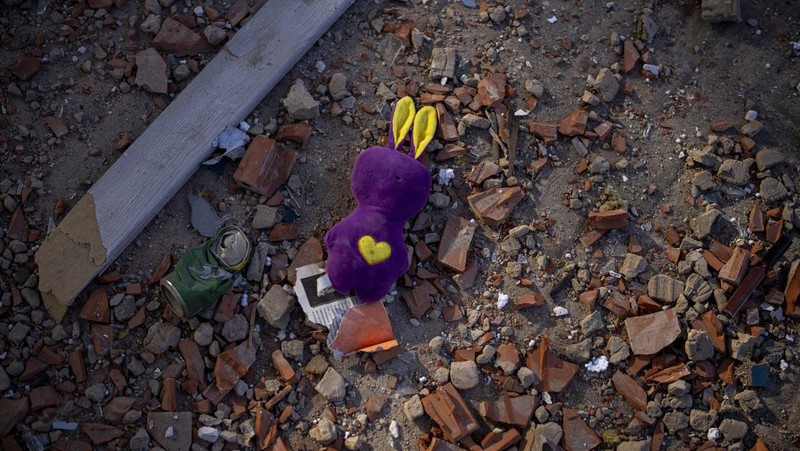 A toy sits among the debris near an apartment building damaged following a rocket attack, in Kyiv, Ukraine, Saturday, Feb. 26, 2022. (AP Photo/Emilio Morenatti)