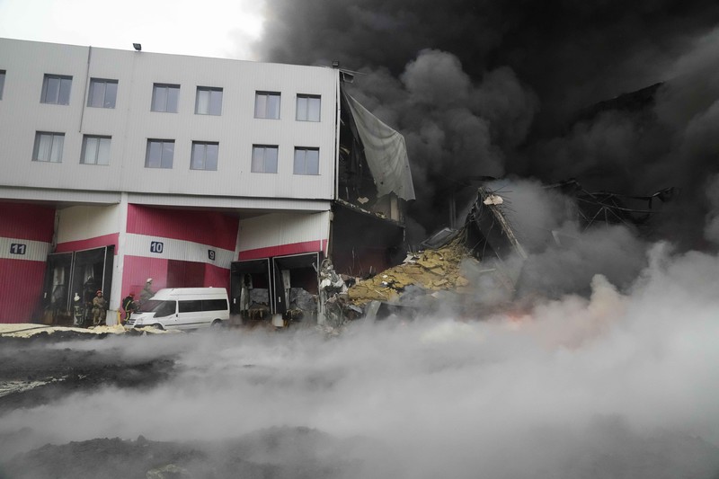A building burns after shelling in Kyiv, Ukraine, Thursday, March 3, 2022. Russian forces have escalated their attacks on crowded cities in what Ukraine's leader called a blatant campaign of terror. (AP Photo/Efrem Lukatsky)