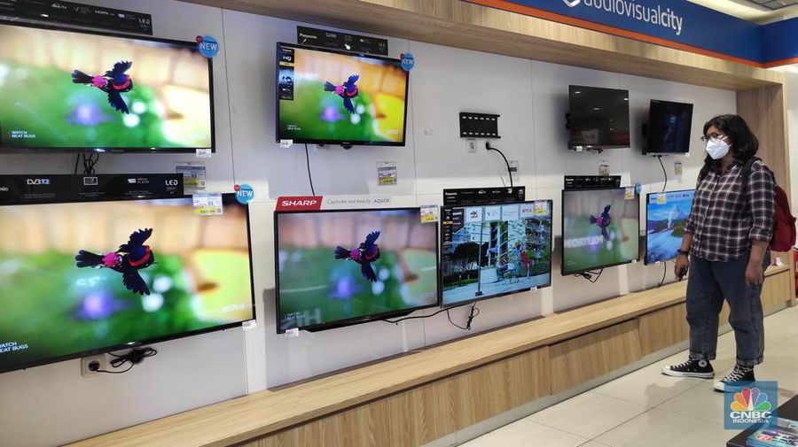 Calon pembeli melihat tv yang dijual disalah satu toko elektronik di Jakarta,  Jumat (4/3/2022). Pemerintah akan segera menghentikan siaran TV analog mulai bulan depan. Saat ini berbagai merek TV berlomba memasarkan produknya dengan persaingan harga. (CNBC Indonesia/Andrean Kristianto)
