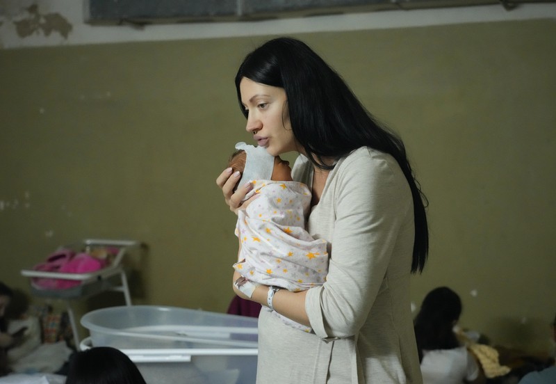 Russia Ukraine War Medical workers tend to women who gave birth in a basement of a maternity hospital converted into a medical ward and used as a bomb shelter in Mariupol, Ukraine, Tuesday, March 1, 2022. Russian strikes on the key southern port city of Mariupol seriously wounded several people. (AP Photo/Evgeniy Maloletka)