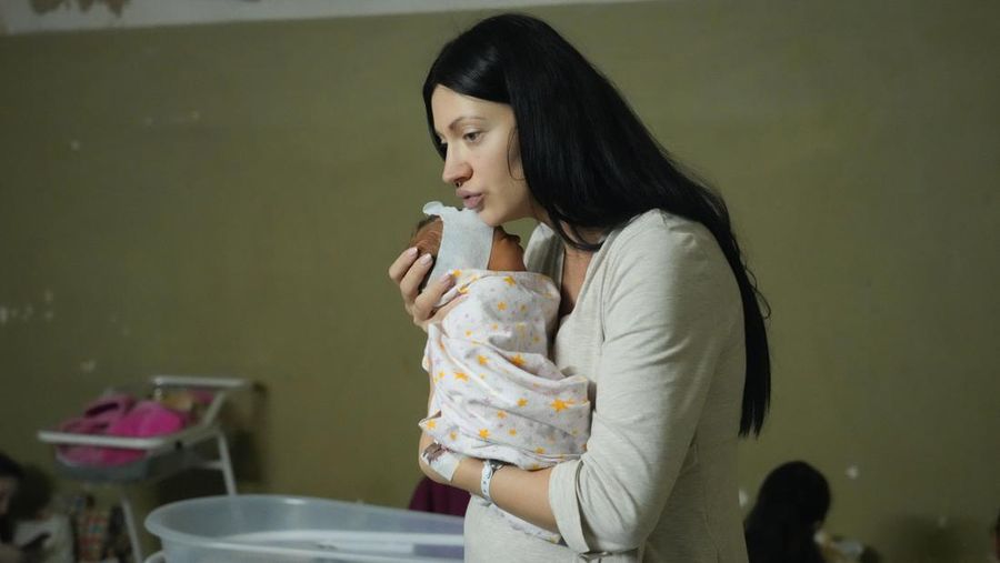 A woman holds her newborn child in the basement of a maternity hospital converted into a medical ward and used as a bomb shelter during air raid alerts, in Kyiv, Ukraine, Wednesday, March 2, 2022. Russian forces have escalated their attacks on crowded cities in what Ukraine's leader called a blatant campaign of terror. (AP Photo/Efrem Lukatsky)
