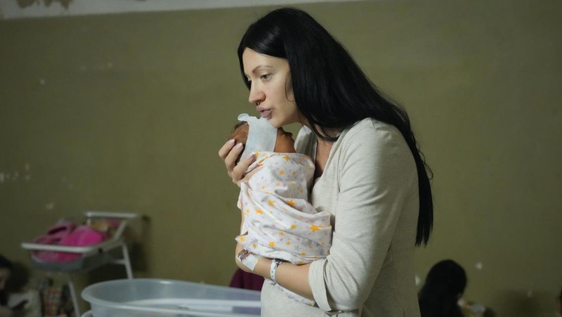 Medical workers tend to women who gave birth in a basement of a maternity hospital converted into a medical ward and used as a bomb shelter in Mariupol, Ukraine, Tuesday, March 1, 2022. Russian strikes on the key southern port city of Mariupol seriously wounded several people. (AP Photo/Evgeniy Maloletka)