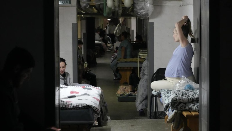 Medical workers tend to women who gave birth in a basement of a maternity hospital converted into a medical ward and used as a bomb shelter in Mariupol, Ukraine, Tuesday, March 1, 2022. Russian strikes on the key southern port city of Mariupol seriously wounded several people. (AP Photo/Evgeniy Maloletka)