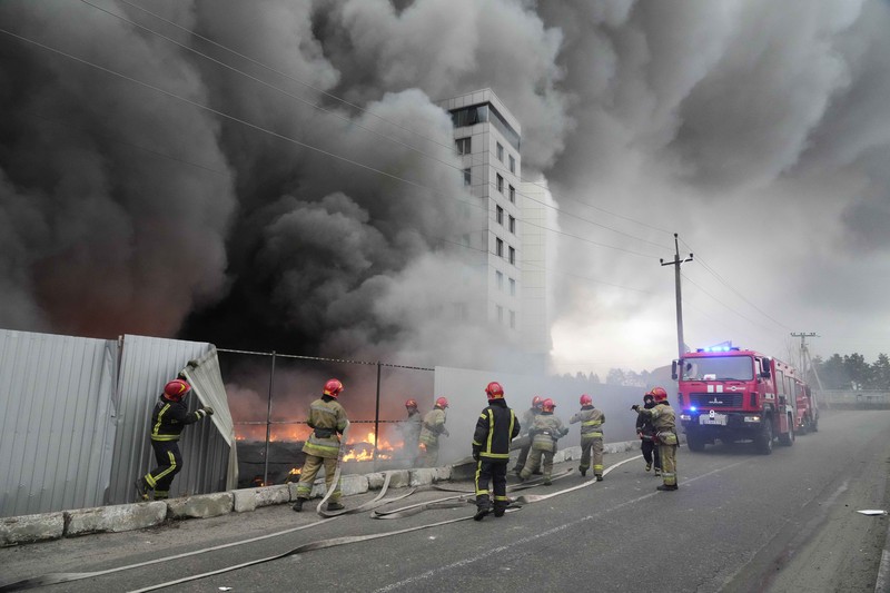 A building burns after shelling in Kyiv, Ukraine, Thursday, March 3, 2022. Russian forces have escalated their attacks on crowded cities in what Ukraine's leader called a blatant campaign of terror. (AP Photo/Efrem Lukatsky)