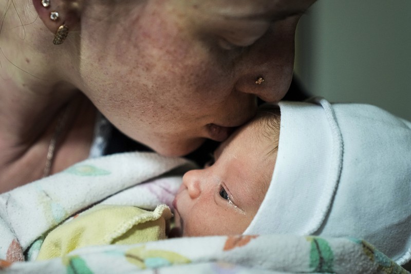 Medical workers tend to women who gave birth in a basement of a maternity hospital converted into a medical ward and used as a bomb shelter in Mariupol, Ukraine, Tuesday, March 1, 2022. Russian strikes on the key southern port city of Mariupol seriously wounded several people. (AP Photo/Evgeniy Maloletka)