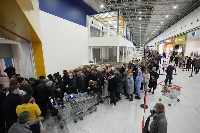 People wait in a line to enter the IKEA store at the outskirts of St. Petersburg, Russia, Thursday, March 3, 2022. IKEA is closing its stores and pausing all sourcing in Russia and Belarus from Friday, March 4. 