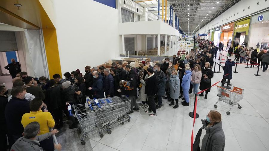 People wait in a line to enter the IKEA store at the outskirts of St. Petersburg, Russia, Thursday, March 3, 2022. IKEA is closing its stores and pausing all sourcing in Russia and Belarus from Friday, March 4. 